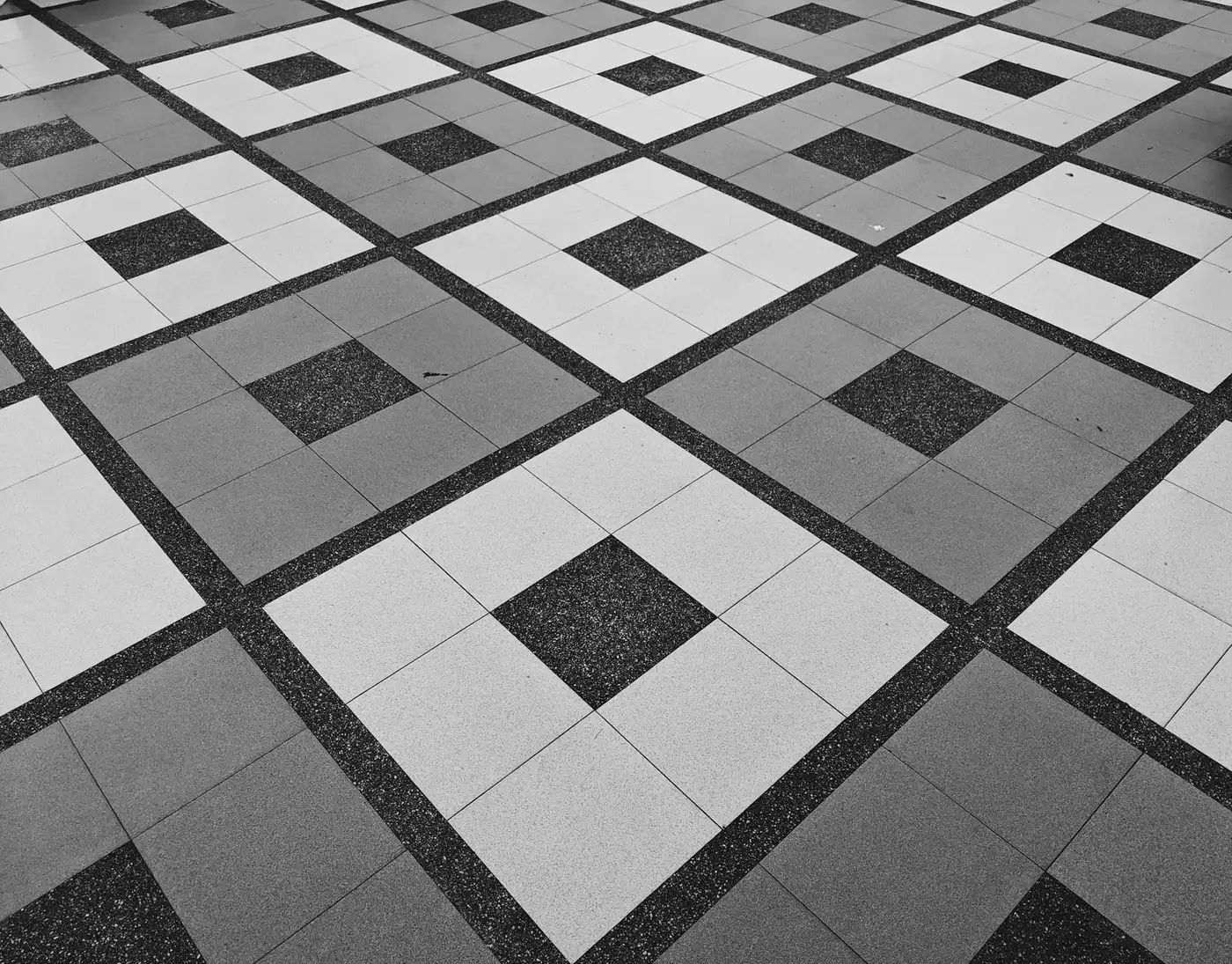Black, gray and white patterned tile paving