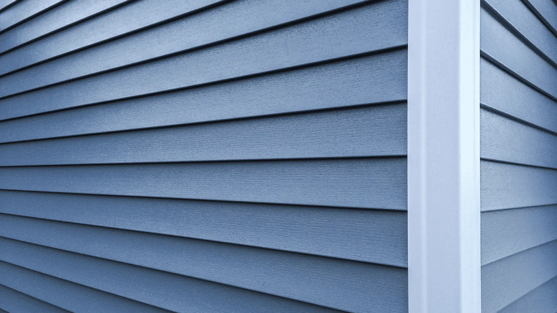 Blue vinyl lap siding with white corner trim