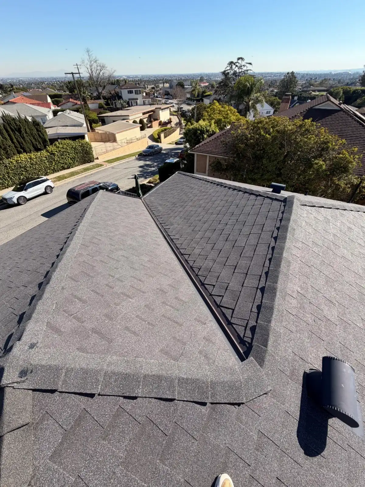 New asphalt shingle hip roof with ridge caps in Los Angeles
