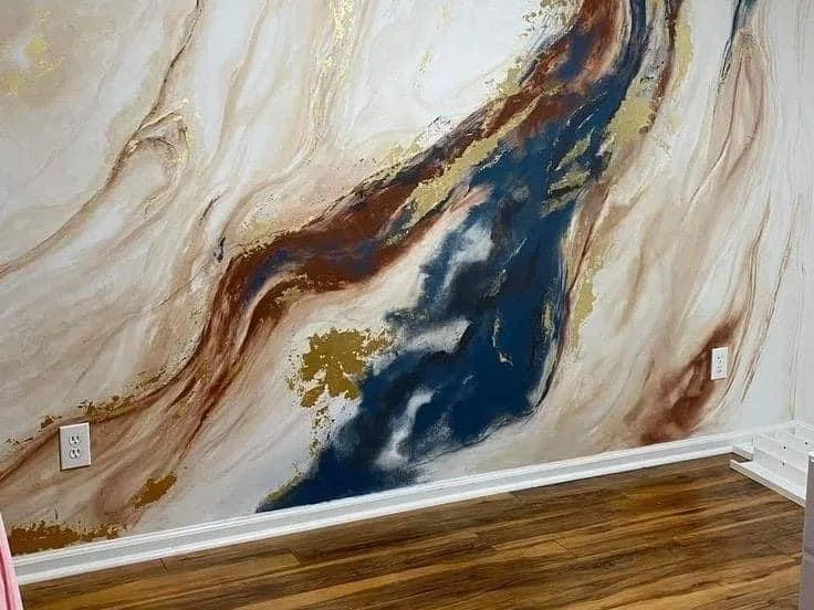 Finished wall with an abstract marble-effect mural above a hardwood floor