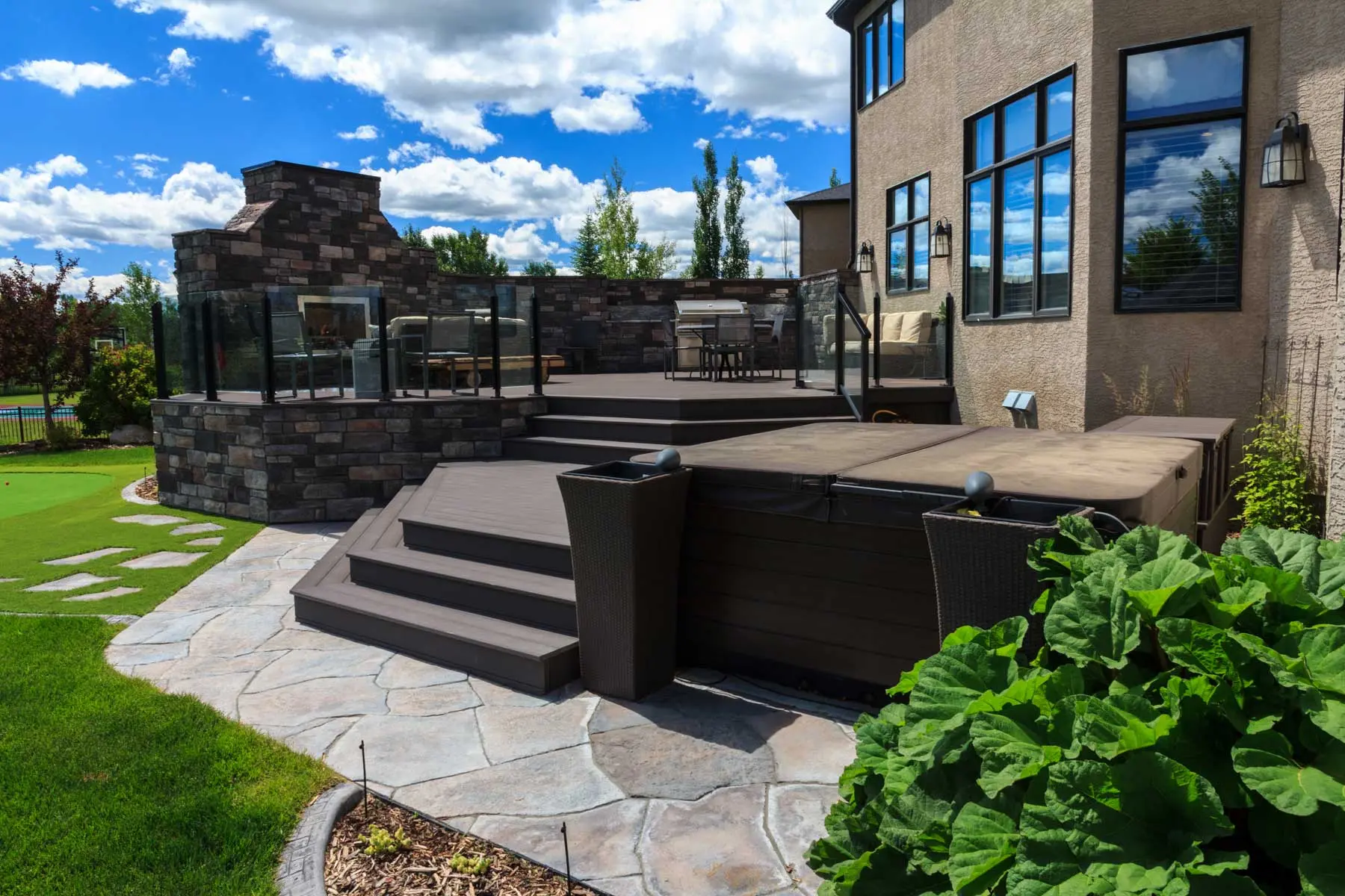 Multi-level deck with a built-in spa and flagstone steps