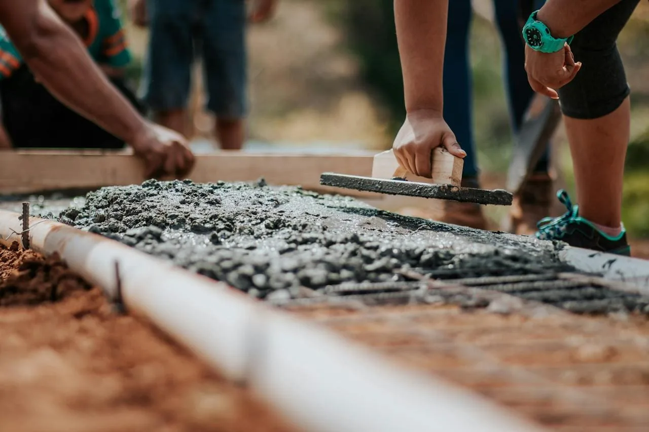 Fresh concrete being smoothed in a form on a new build