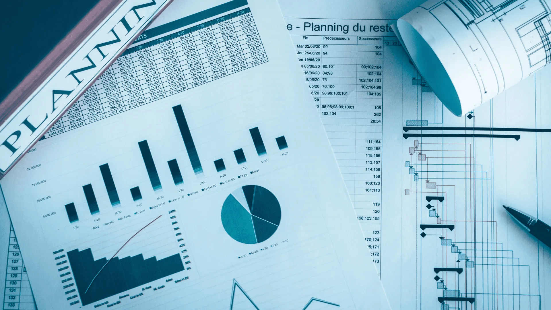 Project planning papers with bar charts, a Gantt schedule and rolled blueprints