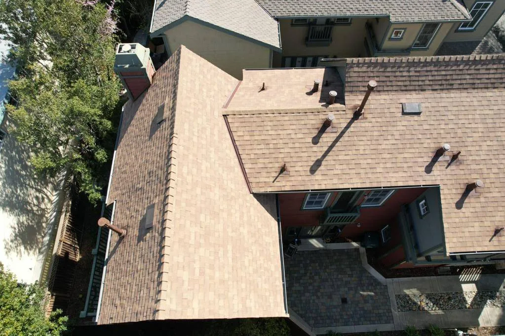 Aerial view of a new tan asphalt shingle roof on a two-storey home at 4105 Wisteria Ln, Palo Alto