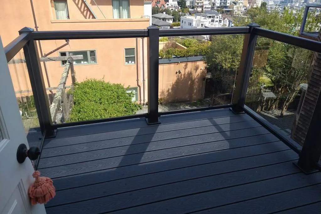 Grey composite balcony deck with black posts and a glass railing at 70 Clifford Ter, San Francisco