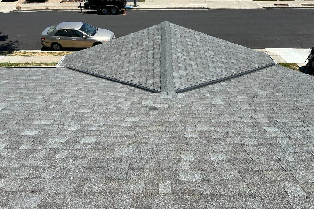 New light grey asphalt shingle hip roof above the street at 7562 Sunwood Dr, Dublin