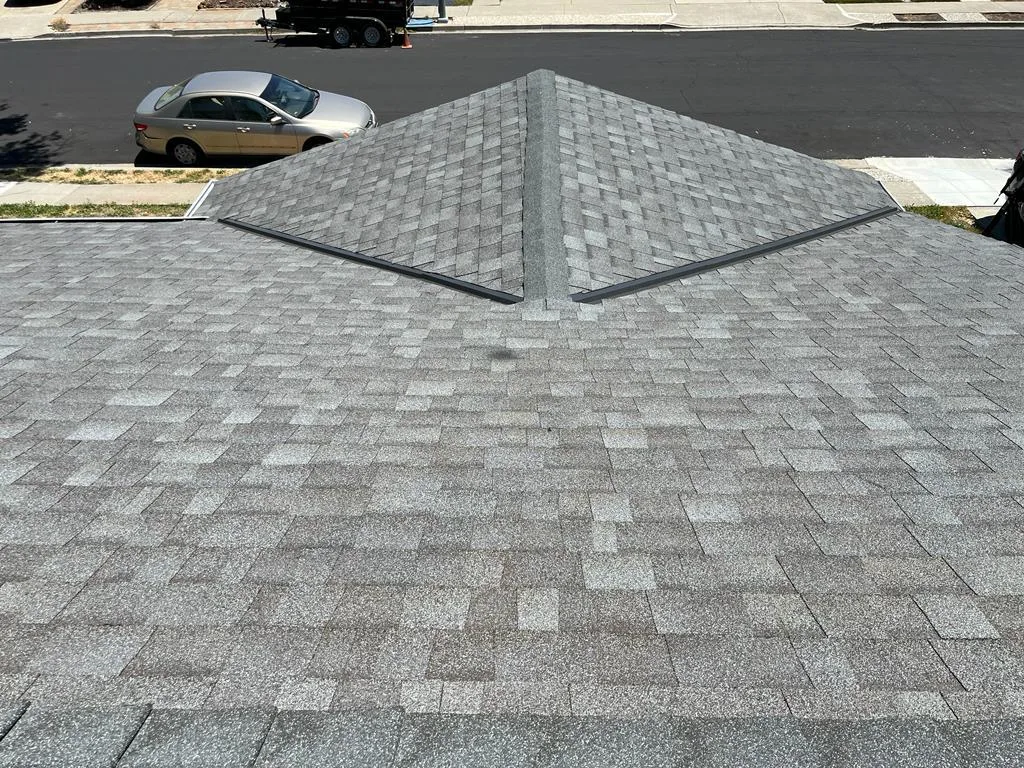 Close view of the new grey architectural shingles and hip ridge caps at 7562 Sunwood Dr, Dublin