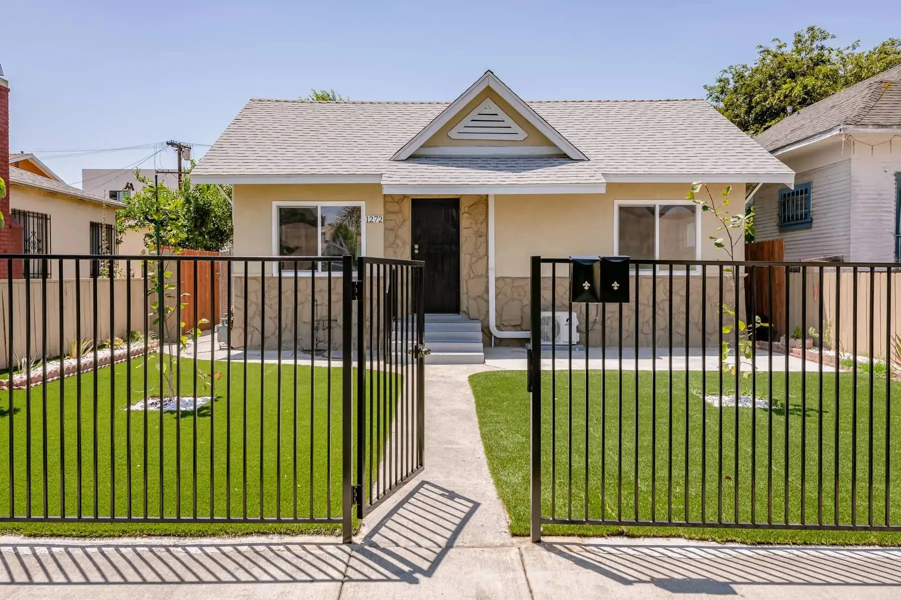 Existing bungalow with an iron fence at W 38th St, Los Angeles, the kind of property a discovery visit starts from