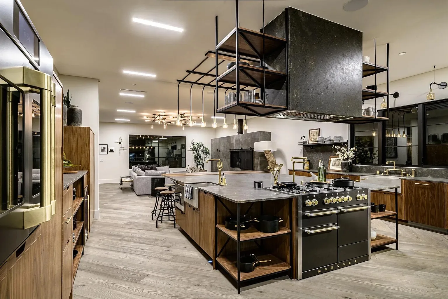 Custom modern kitchen remodel with a black range hood, walnut cabinetry and a hanging pot rack